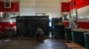 A man cooks on an improvised stove inside the former Velyka Novosilka, Ukraine firehouse, on Aug. 23, 2023 