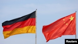 FILE - The flags of Germany and China are seen in Berlin, June 19, 2023. German direct investment in China, however, rose to a record high of 11.9 billion euros last year, underscoring how relevant the market remains despite efforts to reduce exposure.
