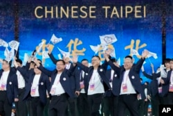 Taiwan's athletes and team officials, competing under the banner of Chinese Taipei, arrive during the opening ceremony of the 19th Asian Games in Hangzhou, China, Sept. 23, 2023.