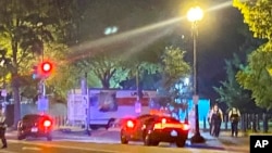 FILE - A box truck is seen crashed into a security barrier at a park across from the White House, Monday night, May 22, 2023, in Washington. Police have arrested a man they believe intentionally crashed the U-Haul truck into the barrier.