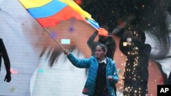 Presidential candidate Luisa Gonzalez, of the Citizen's Revolutionary Movement, waves an Ecuador national flag during a campaign event in Quito, Ecuador, Oct. 11, 2023.