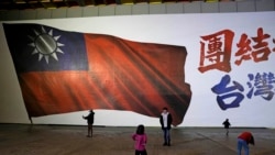 Sekelompok anak terlihat bermain di depan gambar bendera nasional Taiwan di Taipei, Taiwan, Sabtu, 13 Januari 2024. (Foto: AP)