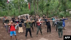 FILE - Members of the People's Defense Force, the armed wing of the civilian National Unity Government opposed to Myanmar's ruling military regime, take part in training at a camp in Kayin State, near the Myanmar-Thai border, Oct. 9, 2021.