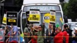 FILE - Hotel workers march and protest while a bus driver waits in traffic, as they continue their strike in Los Angeles, Oct. 25, 2023. 