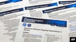 FILE - A Joint Cybersecurity Advisory published by the Cybersecurity & Infrastructure Security Agency about destructive malware that is targeting organizations in Ukraine is photographed, Feb. 28, 2022.