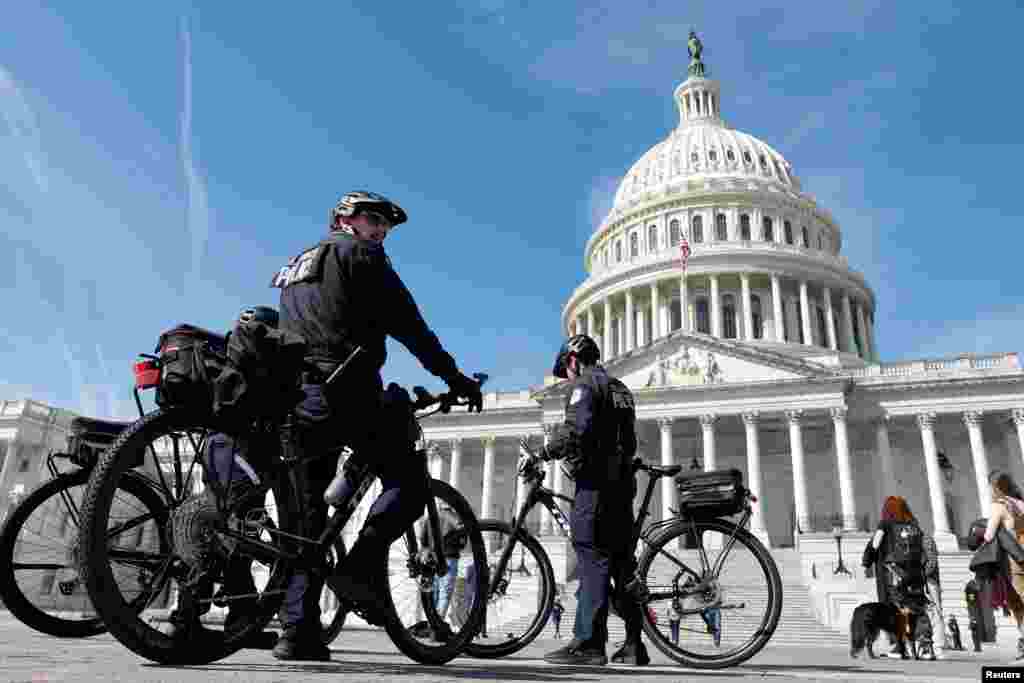 U.S. Capitol Police officers patrol on bicycles as security officials prepare for the possible indictment of former U.S. President Donald Trump over an alleged hush-money payment to porn star Stormy Daniels during his 2016 campaign, at the U.S. Capitol in Washington.
