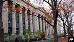 FILE - Students walk through the Harvard Law School area on the campus of Harvard University in Cambridge, Mass., on Nov. 19, 2002. 