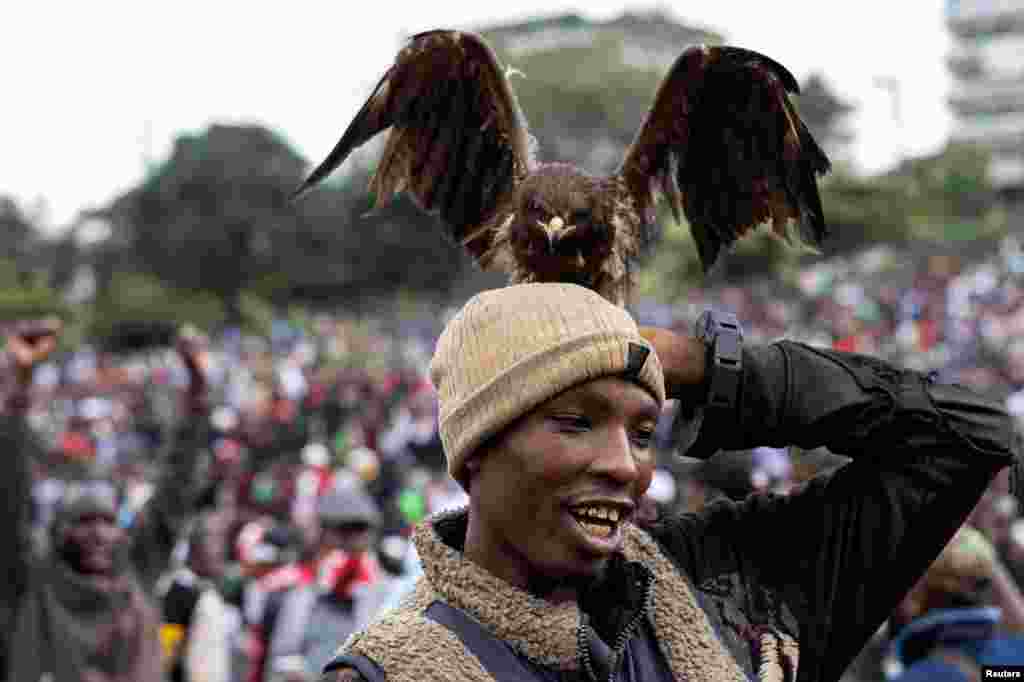 A bird of prey sits on a man&#39;s head at a tribute concert held in honor of the people killed in anti-government protests, in Nairobi, Kenya, July 7, 2024.