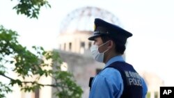 A police officer patrols near the famed Atomic Bomb Dome as Japan's police beef up security ahead of the Group of Seven nations' meetings in Hiroshima, western Japan, May 17, 2023.