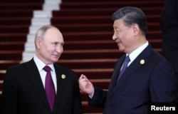 Russian President Vladimir Putin is welcomed by Chinese President Xi Jinping during a ceremony at the Belt and Road Forum in Beijing, China, Oct. 17, 2023. (Sputnik/Sergei Savostyanov/Pool via Reuters)