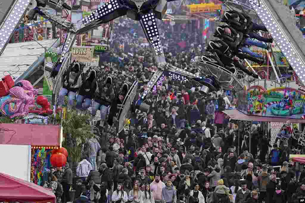 People enjoy a ride at the Easter fun fair in Cologne, Germany, April 1, 2024. 