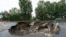 FILE - Train tracks on the Fitchburg Line extend over an area washed out by recent flooding, Sept. 13, 2023, in Leominster, Mass. 