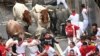 Participants run ahead of Jose Escolar Gil breeder fighting bulls during the seventh bull run of the San Fermin festival in Pamplona, Spain, July 13, 2024.