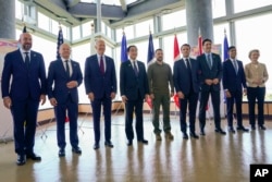 Ukrainian President Volodymyr Zelenskyy, center, meets with G-7 leaders before a working session on Ukraine during the G-7 Summit in Hiroshima, Japan, May 21, 2023.