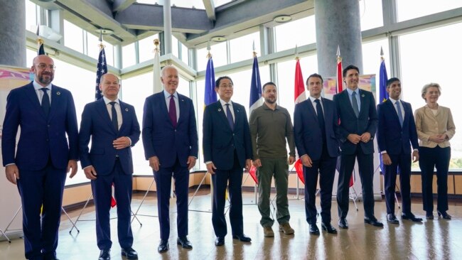 Ukrainian President Volodymyr Zelenskyy, center, meets with G-7 leaders before a session about Ukraine during the G-7 Summit in Hiroshima, Japan, May 21, 2023.