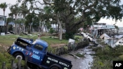 สภาพรถปิ๊กอัพหลายคันและเศษซากความเสียหายจากฤทธิ์ของพายุเฮอร์ริเคนอิดาเลีย ที่พัดผ่านหาดฮอร์สชู รัฐฟลอริดา เมื่อวันที่ 30 ส.ค. 2023. 