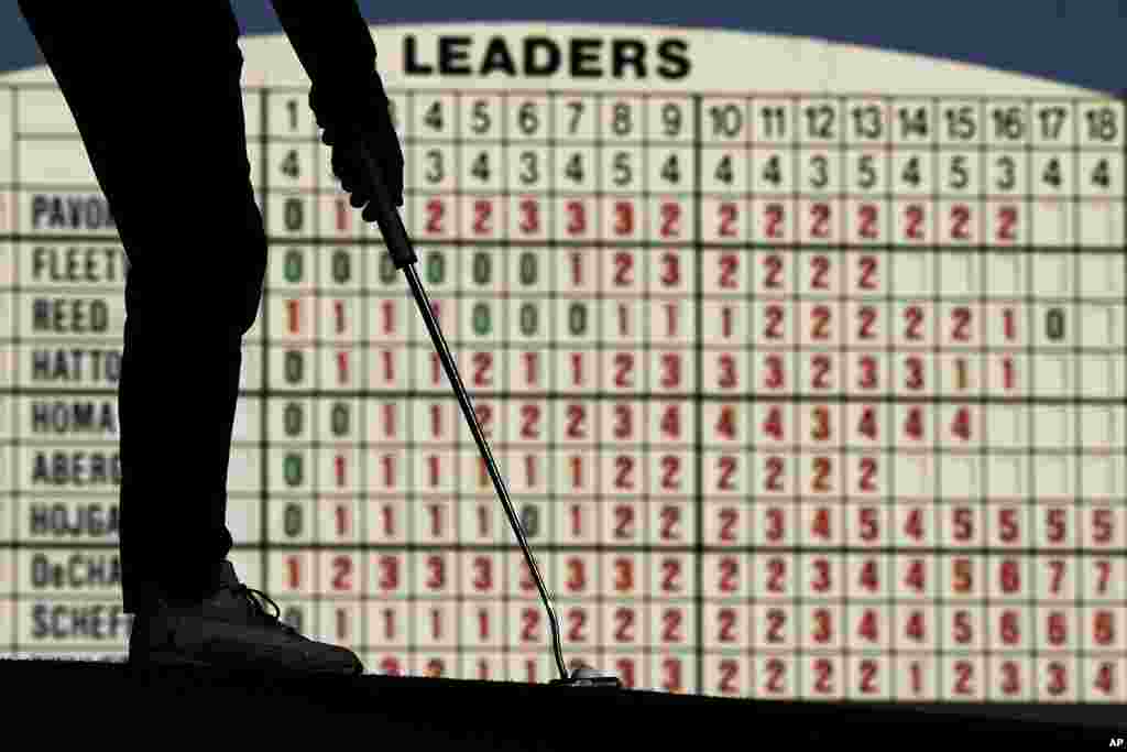 Keegan Bradley putts on the 17th hole during the weather-delayed first round at the Masters golf tournament at Augusta National Golf Club in Augusta, Georgia. 