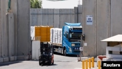 FILE - A truck carries humanitarian aid destined for the Gaza Strip, amid the ongoing conflict in Gaza between Israel and Hamas, at the Kerem Shalom crossing in southern Israel, July 10, 2024.