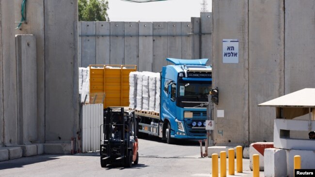 FILE - A truck carries humanitarian aid destined for the Gaza Strip, amid the ongoing conflict in Gaza between Israel and Hamas, at the Kerem Shalom crossing in southern Israel, July 10, 2024.