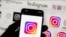 FILE -  The Instagram logo is seen on a cell phone, Oct. 14, 2022, in Boston. Google, Facebook, TikTok and other Big Tech companies operating in Europe are facing far-reaching efforts to clean up what people encounter online. 