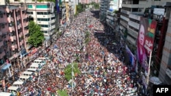 In this aerial photograph Bangladesh Nationalist Party (BNP) activists gather near a poster of BNP chairperson Khaleda Zia, during a rally in Dhaka on Aug. 7, 2024.