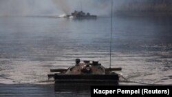 (FILE) Infantry fighting vehicles during a NATO exercise in Poland.