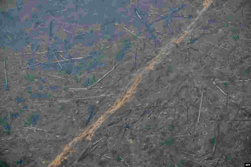 Aerial image of an area of deforested Amazon rainforest covered in smoke from an illegal fire in the municipality of Cujubim, Rondonia State, northern Brazil.