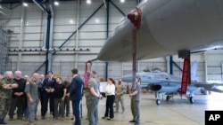 Ukrainian President Volodymyr Zelenskyy, center, and Dutch caretaker Prime Minister Mark Rutte, center right, look at F-16 fighter jets in Eindhoven, Netherlands, Aug. 20, 2023.
