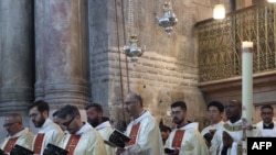 Clergy men attend a mass on Easter Sunday at the Church of the Holy Sepulchre in Jerusalem, Apr. 9, 2023.. 