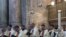 Clergy men attend a mass on Easter Sunday at the Church of the Holy Sepulchre in Jerusalem, Apr. 9, 2023.. 