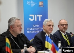 Ukrainian Prosecutor General Andriy Kostin, left, U.S. Attorney General Merrick Garland, center, and National Prosecutor of Poland Dariusz Barski, right, meet in Lviv, Ukraine, March 3, 2023, with a group of international prosecutors to discuss allegations of war crimes committed in Ukraine during Russia's ongoing attack on Ukraine.