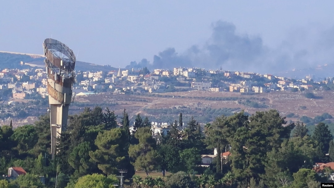 Smoke rises above Lebanon, amid cross-border hostilities between Hezbollah and Israeli forces, as seen from northern Israel, July 25, 2024. 