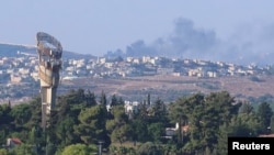 Smoke rises above Lebanon, amid cross-border hostilities between Hezbollah and Israeli forces, as seen from northern Israel, July 25, 2024. 