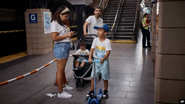 FILE - Migrant Darwin Salinas travels with wife Kimberly Carchipulla and sons Damien, 6, and Derek, 1, June 16, 2024, Jersey City, NJ.