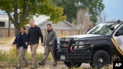 Authorities walk outside the Return to Nature Funeral Home facility where 115 bodies were found in Penrose, Colorado, Oct. 6, 2023.