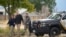 Authorities walk outside the Return to Nature Funeral Home facility where 115 bodies were found in Penrose, Colorado, Oct. 6, 2023.