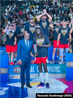 Nuni Omot of Egypt's Al Ahly stands with the 2023 BAL Hakeem Olajuwon Most Valuable Player award at the BK Arena in Kigali, Rwanda, May 27, 2023.