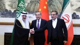 Chinese diplomat Wang Yi, center, poses with Ali Shamkhani, secretary of Iran’s Supreme National Security Council, right, and Musaad bin Mohammed Al Aiban, Saudia Arabia's national security adviser, in Beijing, March 10, 2023. (China Daily via Reuters) 