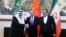 Chinese diplomat Wang Yi, center, poses with Ali Shamkhani, secretary of Iran’s Supreme National Security Council, right, and Musaad bin Mohammed Al Aiban, Saudia Arabia's national security adviser, in Beijing, March 10, 2023. (China Daily via Reuters) 