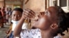 FILE - Eliza Tangwe, 18, takes a dose of oral cholera vaccine at a health center in response to the latest cholera outbreak in Blantyre, Malawi, Nov. 16, 2022.
