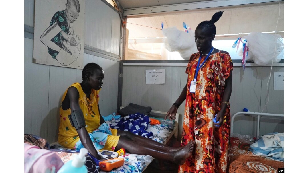 Elizabeth Nyachiew, a midwife supervisor with Doctors Without Borders, checks on patients in the maternity ward at a hospital in Bentiu, South Sudan, June 24, 2024.