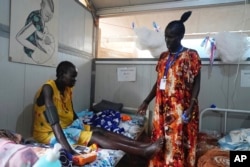 Elizabeth Nyachiew, a midwife supervisor with Doctors Without Borders, checks on patients in the maternity ward at a hospital in Bentiu, South Sudan, June 24, 2024.