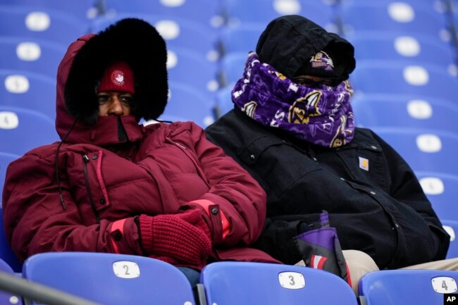 Fans watch teams warm up before an NFL football AFC divisional playoff game between the Baltimore Ravens and the Houston Texans, Jan. 20, 2024, in Baltimore.