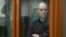 Wall Street Journal reporter Evan Gershkovich stands in a glass cage in a courtroom in Yekaterinburg, Russia, June 26, 2024.