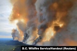 Smoke rises from a wildfire in the Donnie Creek Complex south of Fort Nelson, British Columbia, Canada, May 27, 2023.