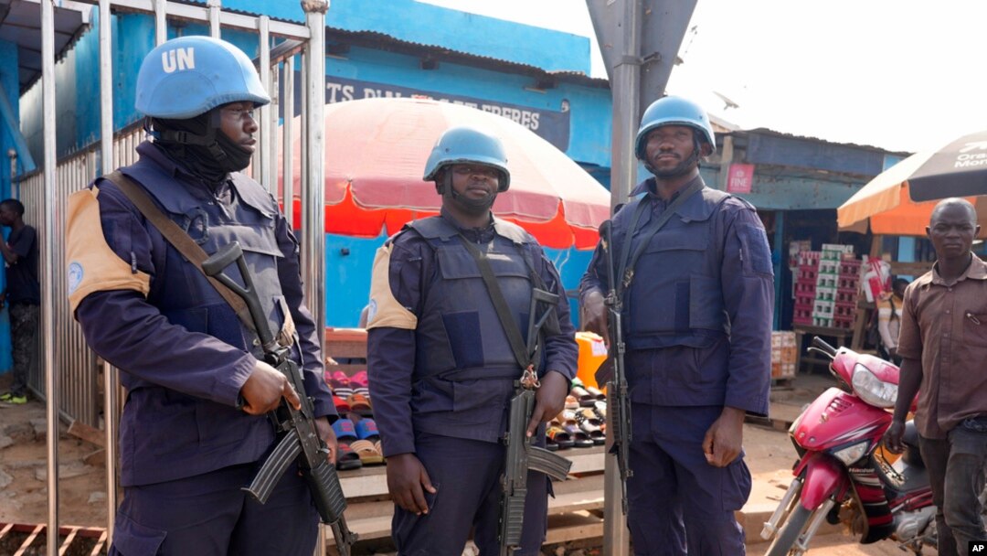 FILE - United Nations peacekeepers stand in the market in Bouar, Central African Republic, March 8, 2024. Nearly 5,000 fighters have put down their arms in Central African Republic since a disarmament program launched nearly a decade ago. 