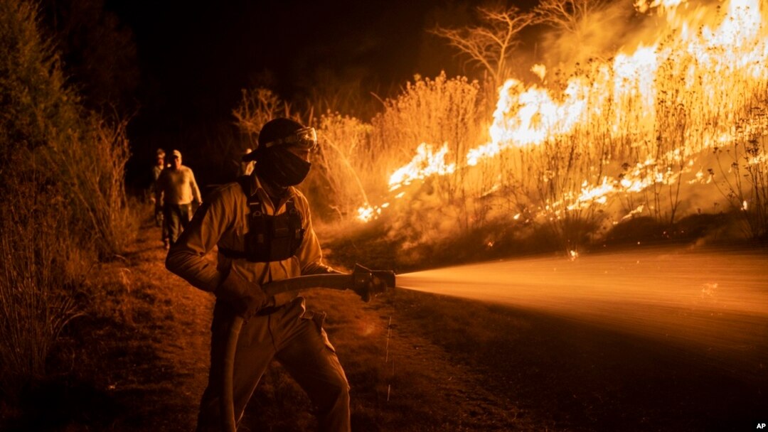 A firefighter works to contain wildfires in Nogales, in Veracruz state, Mexico, March 25, 2024.