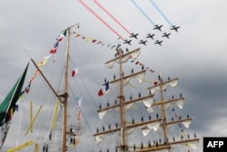 FILE - French aircraft patrol "Patrouille de France" planes fly over the Cuauhtemoc ship during the Grand Parade during the Armada of old vessels and tall ships in Rouen, June 18, 2023. (Photo by Lou BENOIST / AFP)