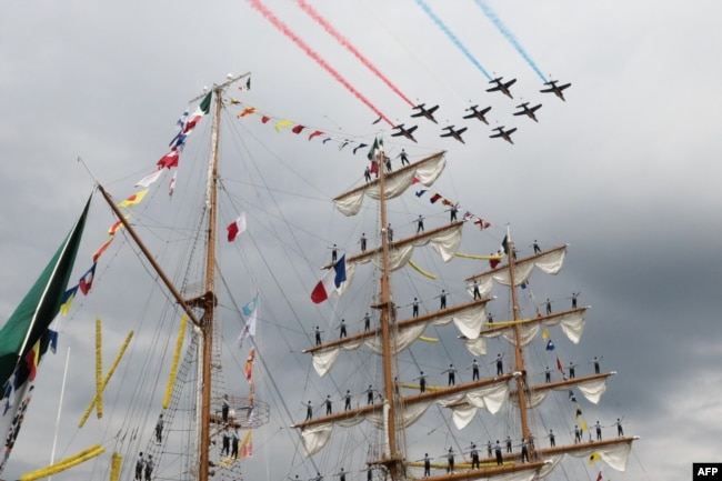 FILE - French aircraft patrol "Patrouille de France" planes fly over the Cuauhtemoc ship during the Grand Parade during the Armada of old vessels and tall ships in Rouen, June 18, 2023. (Photo by Lou BENOIST / AFP)