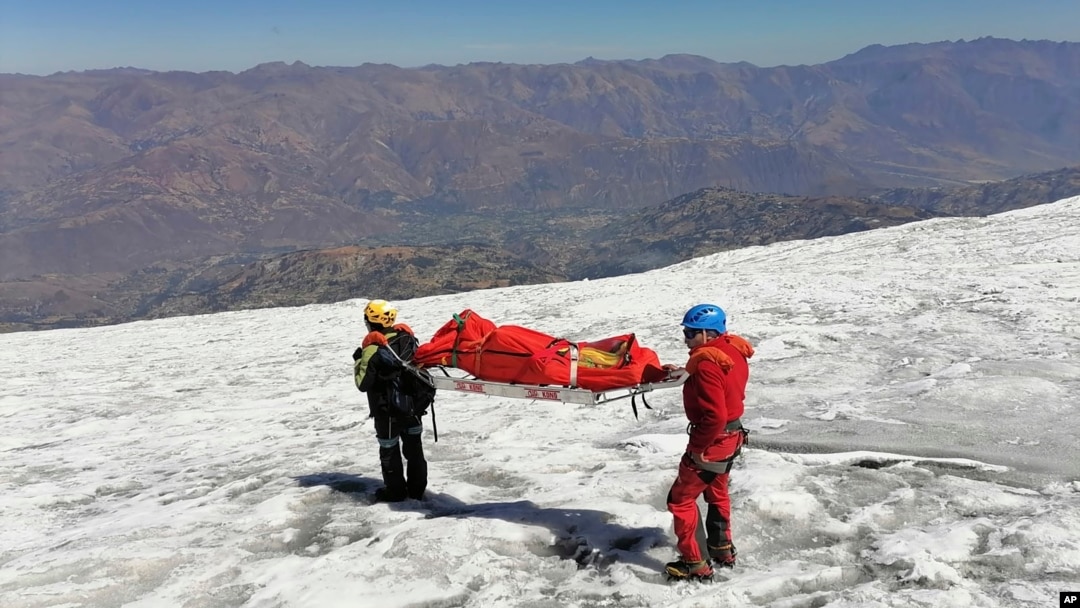 This photo distributed by the Peruvian National Police shows police carrying a body that they identify as U.S. mountain climber William Stampfl, on Huascaran mountain in Huaraz, Peru, July 5, 2024. Stampfl was buried in an avalanche in 2002.